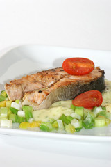 grilled salmon fillet on mashed potato and spring onion