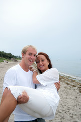 Young partners having fun by the beach