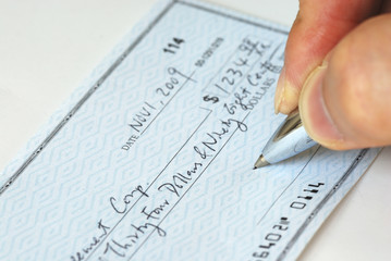 Writing a check to pay for the bill