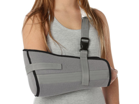Woman wearing an arm brace over white