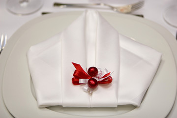 Detail of a plate and a napkin ready for dinner