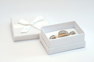 Golden ring and earrings in a white gift box