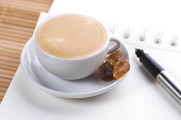 pen, notebook and cup of coffee