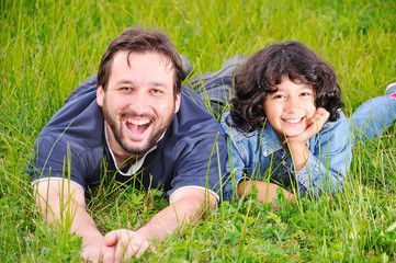 Fototapeta premium Young father and little cute girl, happiness on meadow