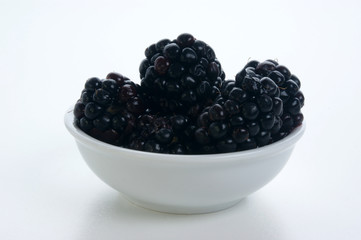 some organice blackberries in a white bowl