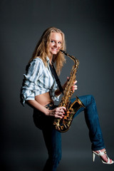 Fototapeta na wymiar sexy happy funny young blonde girl with saxophone isolated