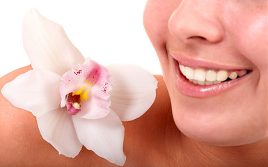 Girl lips and orchid flower. Spa salon.Isolated.