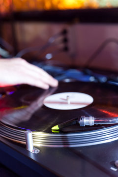 dj is scratching on a turntable