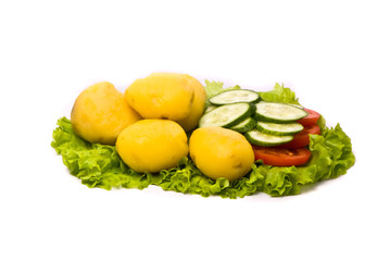 Cooked potatoes with fresh cucumbers and tomatoes on studio whit