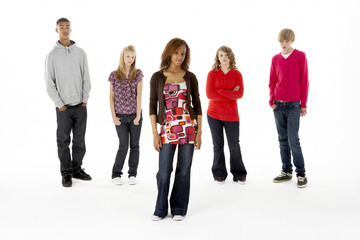 Full Length Studio Portrait Of Five Teenage Friends