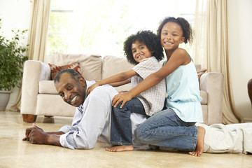 Grandfather Playing With Grandchildren At Home