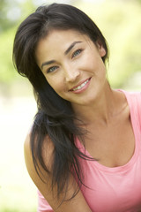 Portrait Of Young Woman In Park