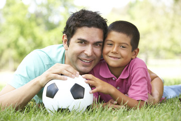 Fototapeta premium Father And Son In Park With Football