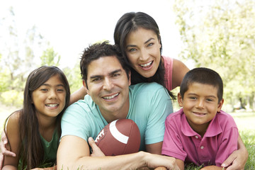 Family In Park With American Football