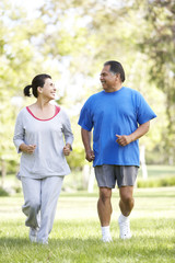 Senior Couple Jogging In Park