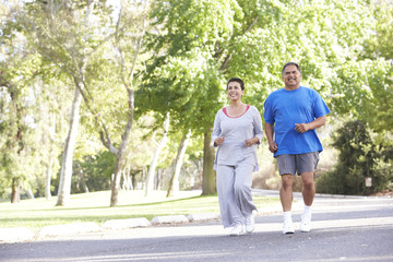 Obraz premium Senior Couple Jogging In Park