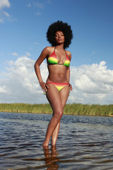 Cute black girl in rainbow glow bikini