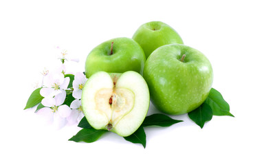Some ripe, green apples and white flowers .