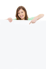 Joyful woman  showing on blank white billboard