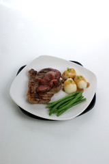 grilled rump steak and bacon with organic vegetable
