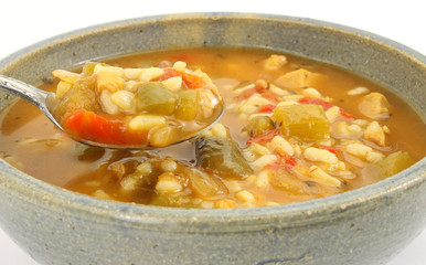 Chicken soup in stoneware bowl with spoon