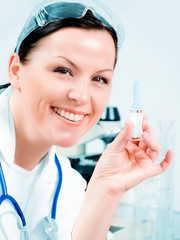 smiling female doctor holding medicine vial in laborato