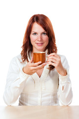 Woman drinking tea with cup under her face