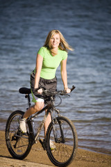 Fototapeta premium Woman riding bike on beach