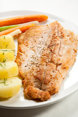 Fish dish - fried fish fillet with potatoes and vegetables