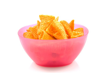 Pink bowl filled with potato chips over white background