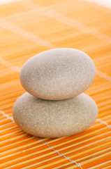 Fototapeta na wymiar Stack of spa pebbles against blurred background
