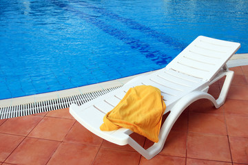 relax chair near the pool with towel