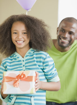 African father and daughter with gift