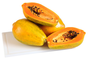 Papaya on cutting board. Clipping path.