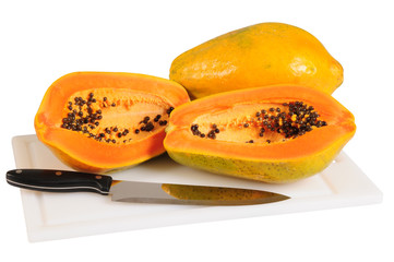 Papaya on cutting board. Clipping path.