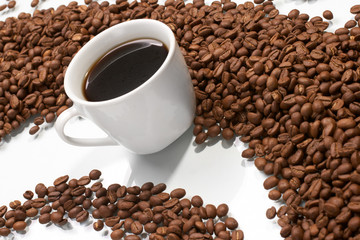 Cup with coffee, costing on coffee grain