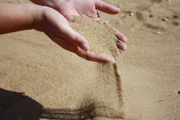 Sand flows down from palms