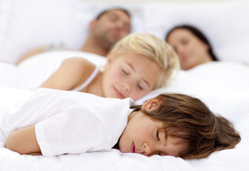 Children sleeping with his parents