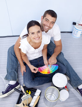 High angle of couple chosing colours to paint new house