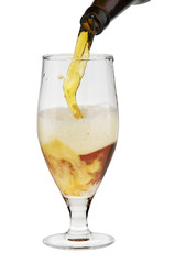 Alcohol dark beer with froth being poured into a glass isolated.