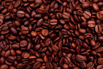 Top view of brown coffee beans forming background