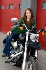 Fototapeta na wymiar Young Woman Sitting on Motorcycle
