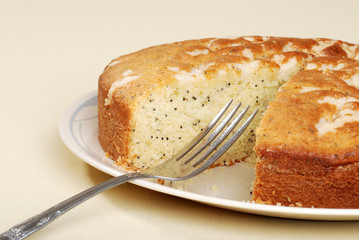 cut lemon poppy seed cake with a fork