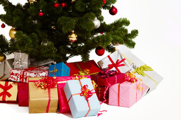 Fototapeta na wymiar Christmas - Presents under a tree on white