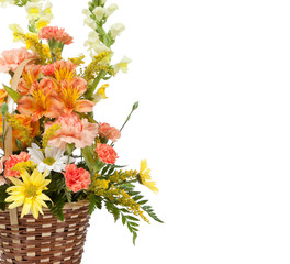 Various flowers arranged in basket on a white background