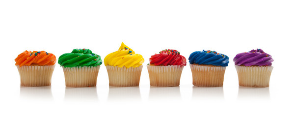 Assorted colored Cupcakes with sprinkles on white