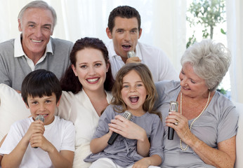 Family singing karaoke in living-room