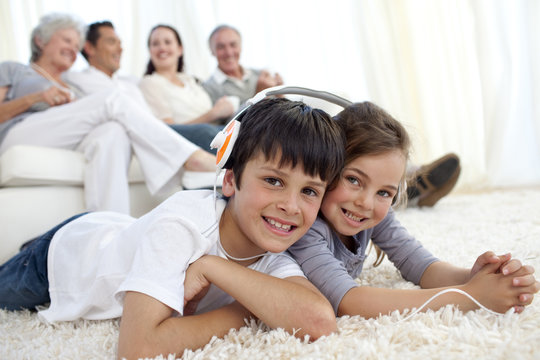 Children on floor listening to the music in living-room