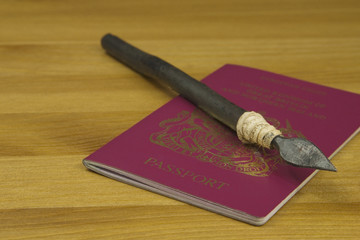 Close up shot of a Red British Passport with a Zulu Spear on top