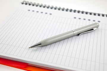 pen and paper orange notebook